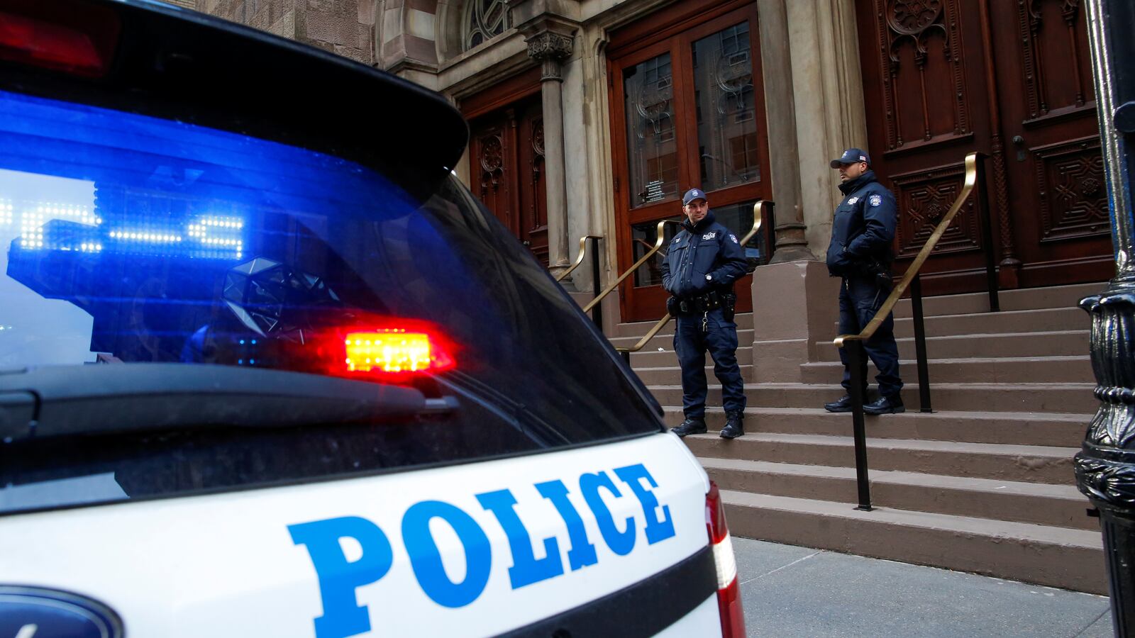 New York Police Department officers stand guard at Central Synagogue in New York, Dec. 11, 2019.