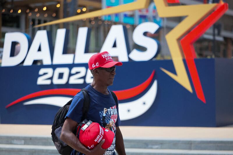 A man selling Trump hats walks near the American Airlines Center, as preparations are underway for the Republican National Midterm Convention in Dallas, Texas, U.S., September 7, 2026.   REUTERS/Jessica Koscielniak