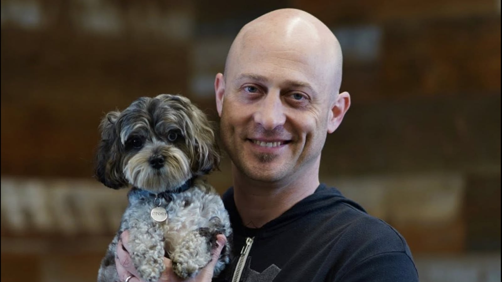 Joshua Baer holding a dog in a photo posted to his facebook.