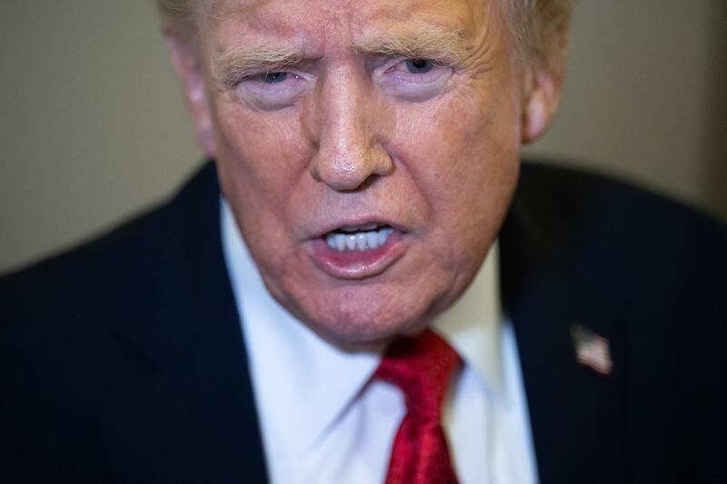 US President Donald Trump speaks with the media aboard Air Force One prior to landing at Joint Base Andrews in Maryland, October 19, 2025.