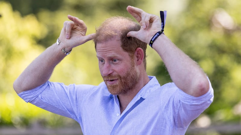 Prince Harry motions to his balding head as he takes part in Goat Yoga during Scotty’s Summer Festival at Maxstoke Castle in 2026.