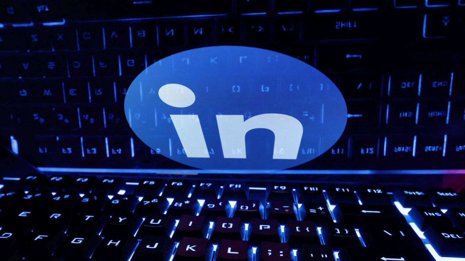 A keyboard is placed in front of a displayed LinkedIn logo in this illustration taken February 21, 2023.