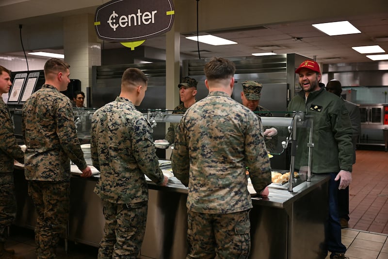 US Vice President JD Vance (R) serves food to soldiers as he tours the Marine Corps Base in Quantico, Virginia, on March 26, 2025. (Photo by Jim WATSON / AFP) (Photo by JIM WATSON/AFP via Getty Images)