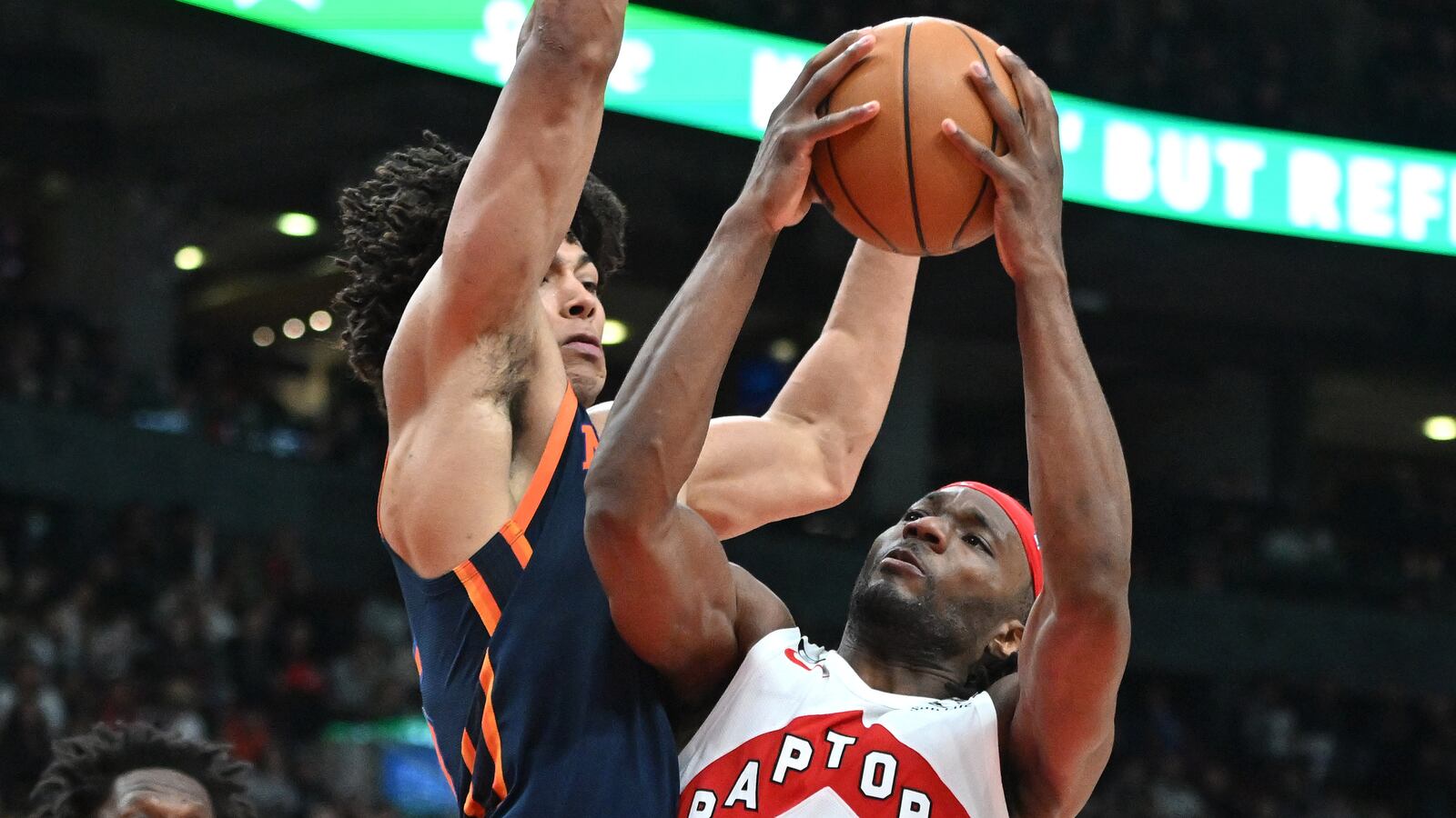 Toronto Raptors forward Precious Achiuwa shoots the ball as New York Knicks center Jericho Sims defends in the second half at Scotiabank Arena.
