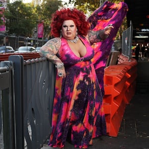 Drag Icon Maxi Shield poses against  the cycle way construction site (along Mardi Gras parade route on Oxford st)