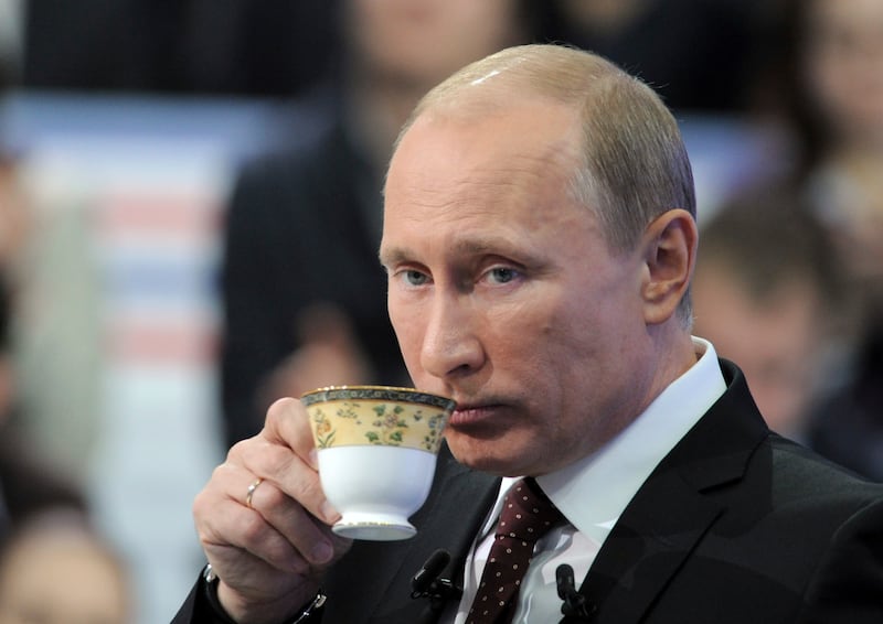Russian Prime Minister Vladimir Putin drinks during a televised questions and answers session in Moscow December 15, 2011. Putin on Thursday deflected opposition allegations that fraud helped his ruling party win a parliamentary election, saying the result reflected the views of the population. REUTERS/RIA Novosti/Pool (RUSSIA - Tags: POLITICS) THIS IMAGE HAS BEEN SUPPLIED BY A THIRD PARTY. IT IS DISTRIBUTED, EXACTLY AS RECEIVED BY REUTERS, AS A SERVICE TO CLIENTS