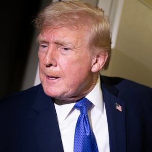 President Donald Trump speaks to members of the media aboard Air Force One while flying from Palm Beach International Airport on February 16, 2026 en route to Washington, DC.