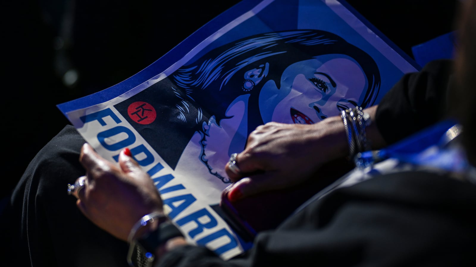 An attendee holds a poster depicting Democratic presidential candidate, U.S. Vice President Kamala Harris during the first day of the Democratic National Convention at the United Center on August 19, 2024 in Chicago, Illinois.