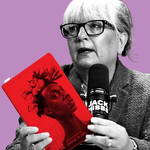 Karen England holds a book she has targeted for bans. 