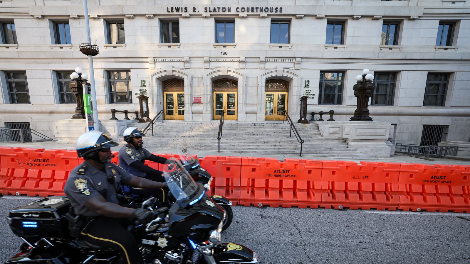Sheriff motorcycles pass by the Lewis R. Slaton Courthouse and Superior Court of Fulton County, after a Grand Jury brought back indictments against former U.S. President Donald Trump and 18 of his allies.