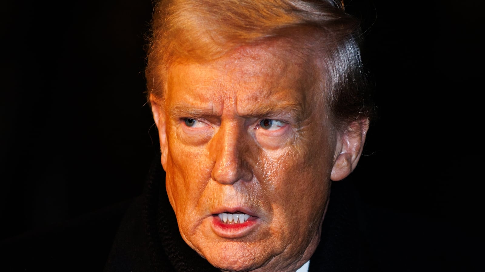 President Donald Trump walks over to reporters to make a brief statement before departing from the South Lawn of the White House in Marine One on January 20, 2026 in Washington, DC.