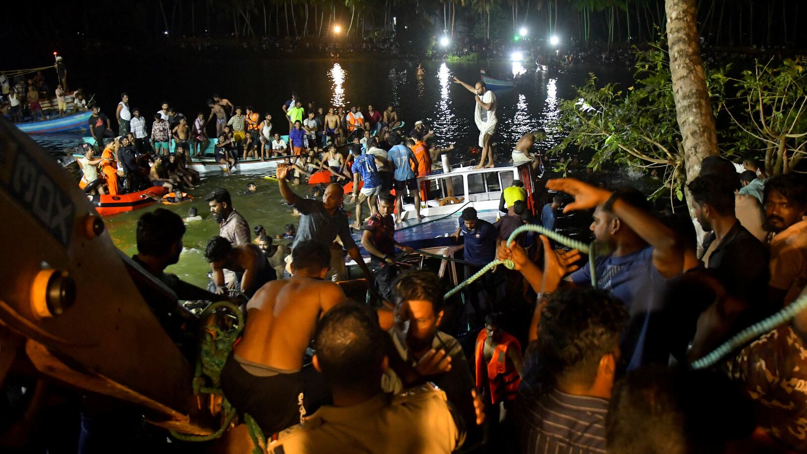 Rescue team members search for survivors after a boat capsized off the coastal town of Tanur in the Malappuram district of the southern state of Kerala, India, May 7, 2023.