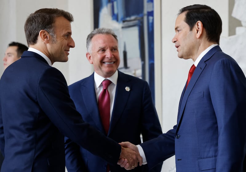 France's President Emmanuel Macron (L) shakes hands with US Secretary of State Marco Rubio (R) next to US Special Envoy Steve Witkoff before a meeting at the Elysee presidential palace in Paris on April 17, 2025.