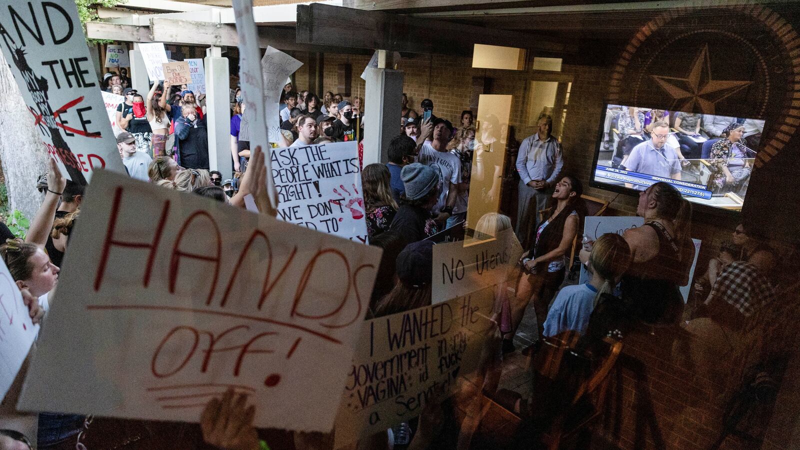 Pro-abortion protesters hold signs up in Denton, Texas.