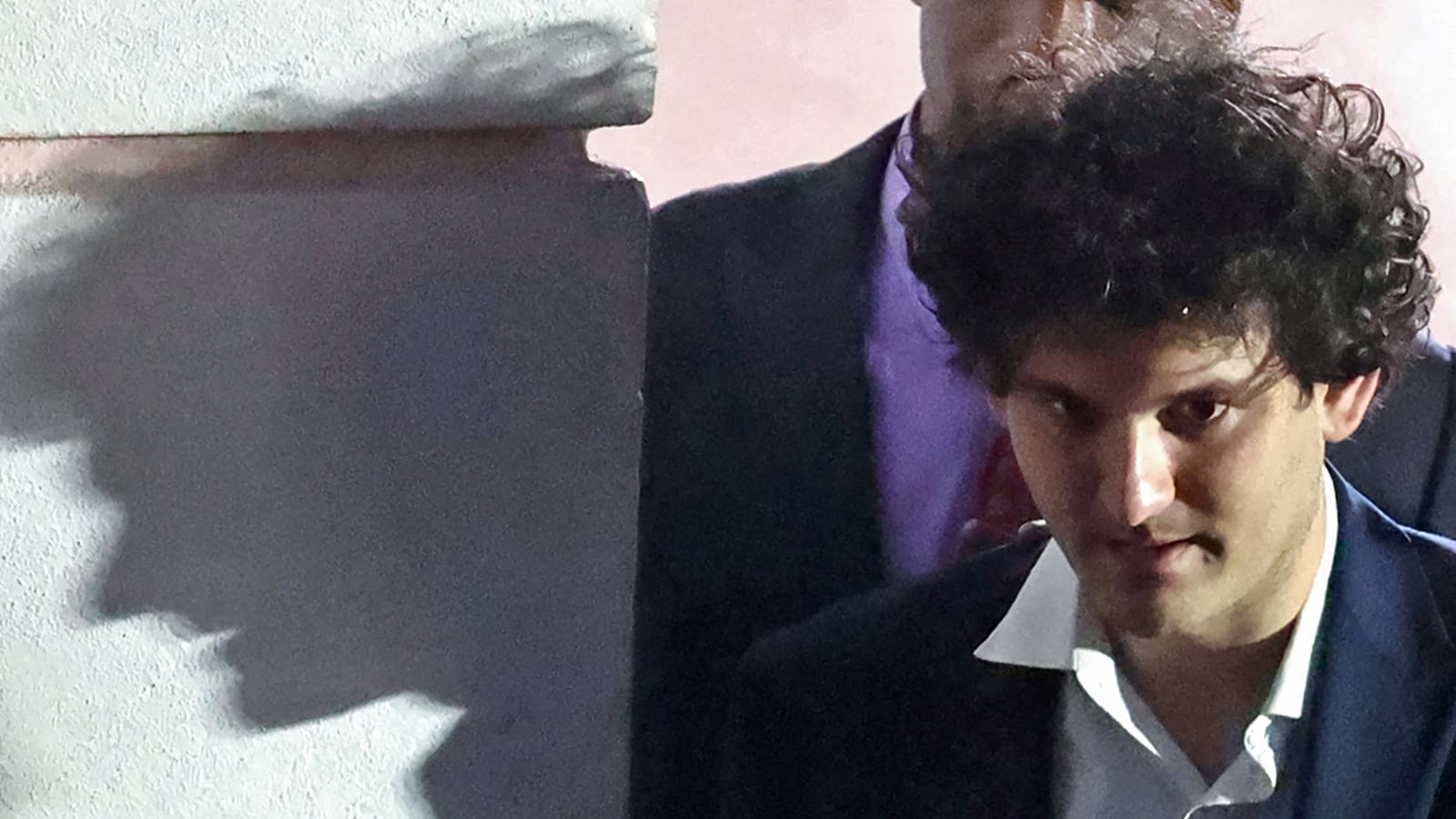 Sam Bankman-Fried is escorted out of the Magistrate Court building after his arrest in Nassau, Bahamas December 13, 2022.