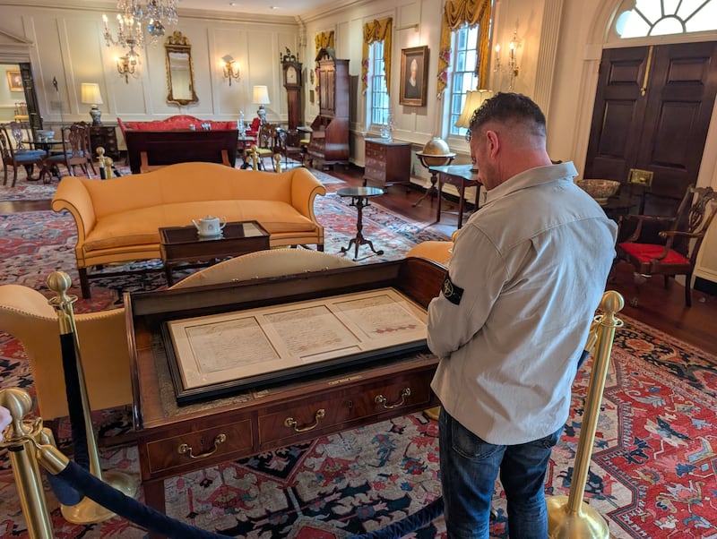 Johnson at the Treaty of Paris Desk in the John Quincy Adams State Drawing Room at the State Department.