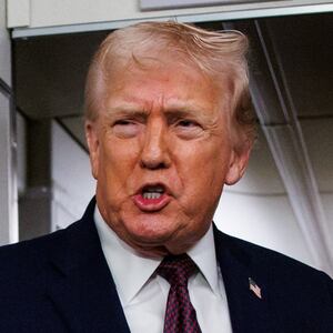 U.S. President Donald Trump takes questions from the members of the press aboard Air Force One on January 11, 2026 en route back to the White House from Palm Beach, Florida.