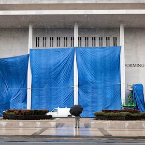 Workers begin adjusting the name of the “John F. Kennedy Memorial Center for the Performing Arts" on December 19, 2025 in Washington, DC. The Kennedy Center Board of Trustees voted in what they say was a unanimous decision to rename the facility “The Donald J. Trump and The John F. Kennedy Memorial Center for the Performing Arts”.