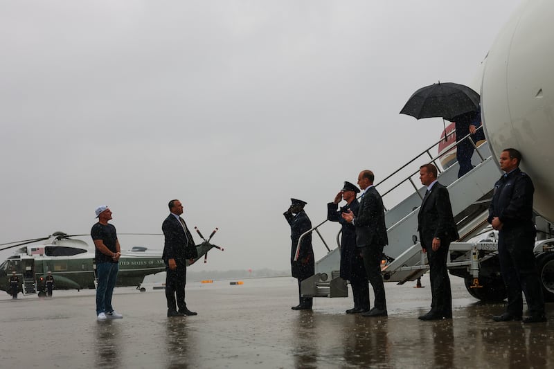 Sports analyst Pat McAfee (L) greets U.S. President Donald Trump (R) as he arrives at the Cleveland Hopkins International Airport on August 11, 2026 in Cleveland, Ohio. President Trump is traveling to Ohio to attend the 2026 Patriot Games.