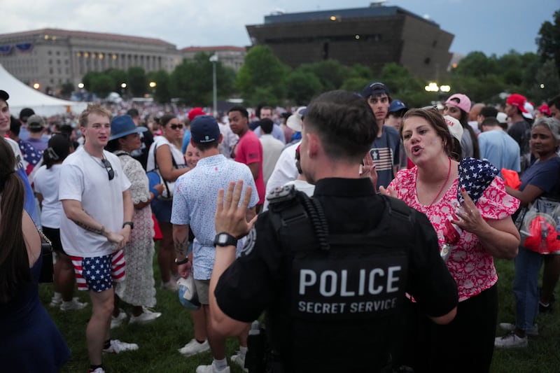 A federal agent asks the attendees to evacuate as stormy weather approaches the National Mall.