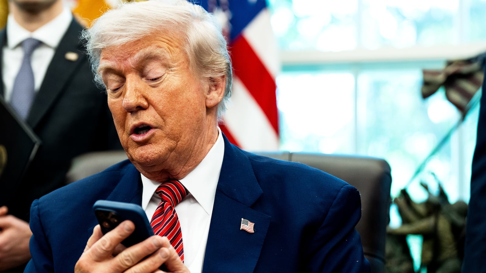 President Donald Trump, pictured silencing his cellphone in the Oval Office on May 23, has long been known for picking up the phone and making calls to reporters to get his side of a story out.