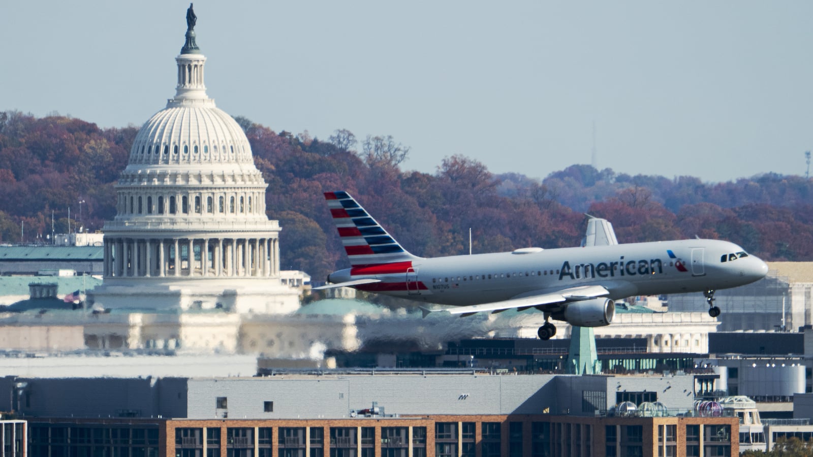 UNITED STATES - NOVEMBER 7: An American Airlines Airbus A320 plane passes by the U.S. Capitol dome in Washington as it comes in for a landing at Ronald Reagan Washington National Airport on Friday, November 7, 2025. Starting today the Federal Aviation Administration forced airlines to cut 10% of flights at 40 busy airports, including Washington National, to reduce the load on air traffic controllers during the government shutdown. (Bill Clark/CQ-Roll Call, Inc via Getty Images)