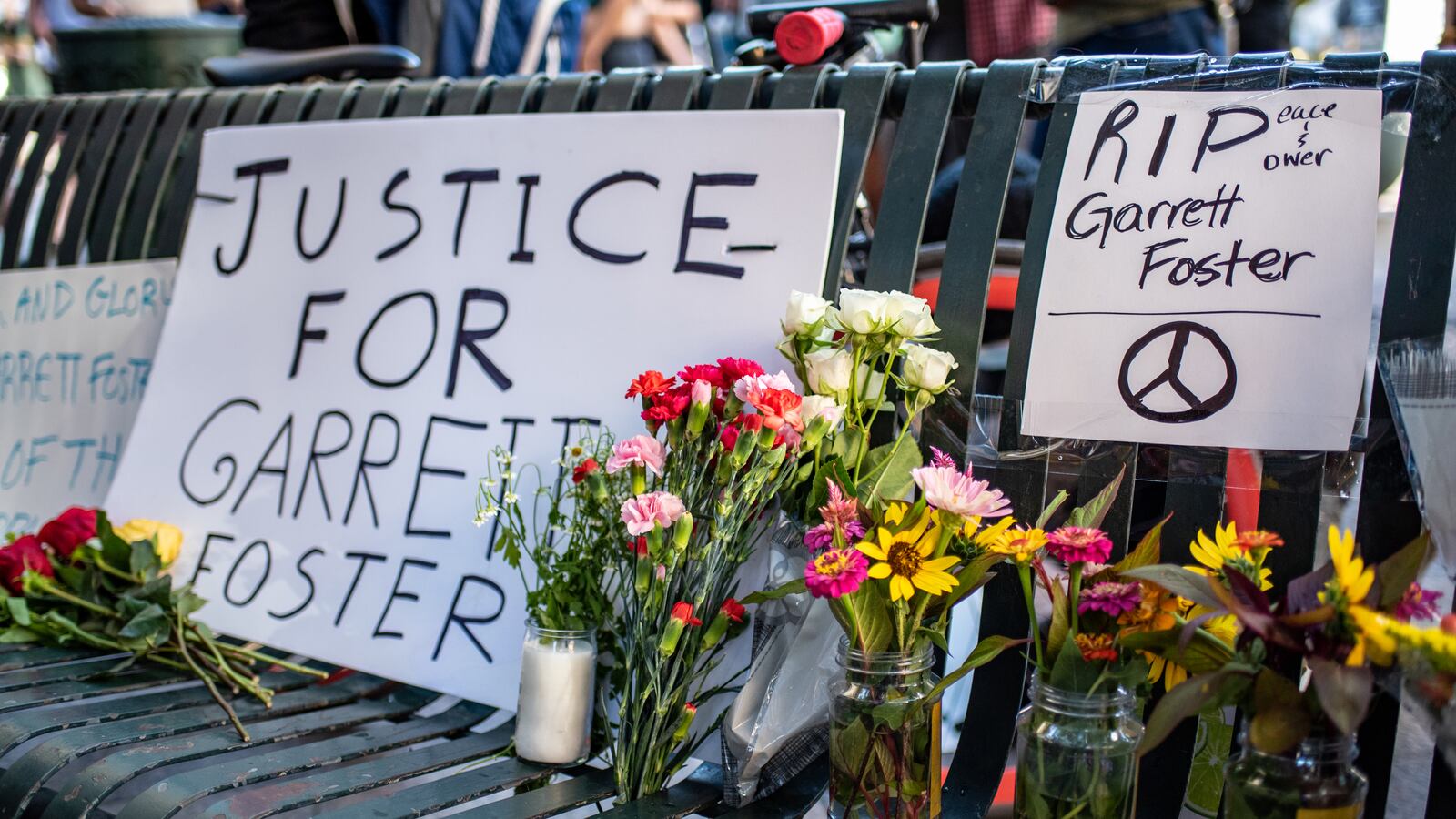Signs and flowers at a vigil for Garrett Foster on July 26, 2020 in downtown Austin, Texas