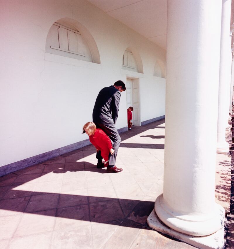 President John F. Kennedy playing with his children outside the West Wing of the White House in 1963.