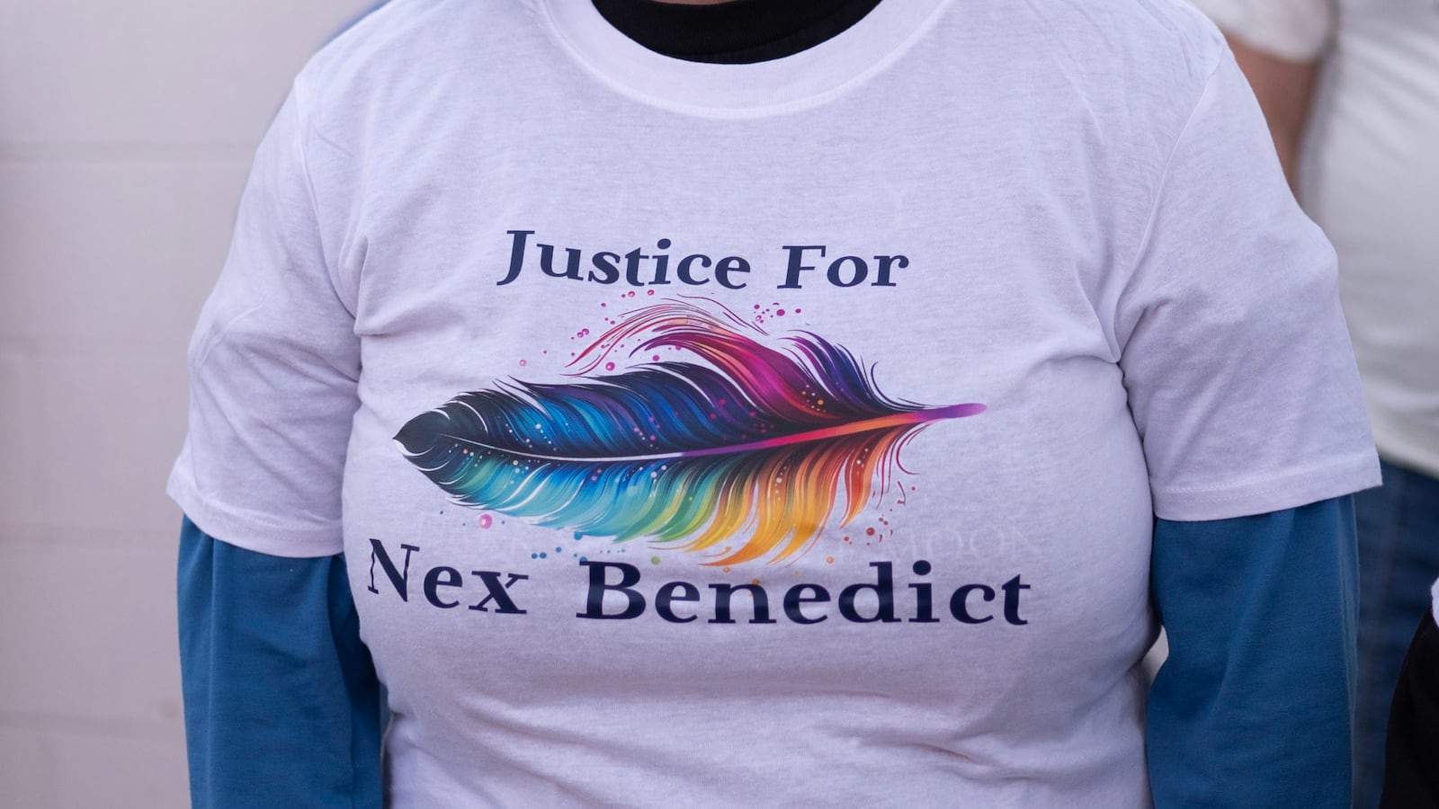 People attend a candlelight vigil for 16-year-old nonbinary student Nex Benedict.