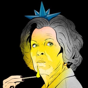 Susie Wiles as an Ice Queen holding a match illuminating her face