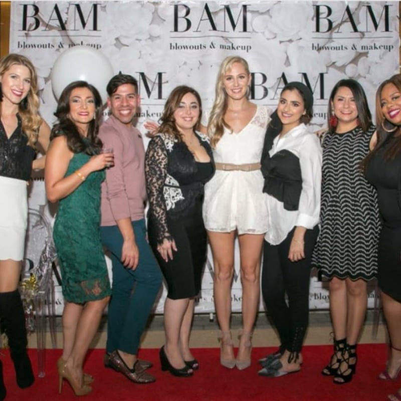 Mora Namdar, centre in black, photographed with her beauty salon team in 2017.