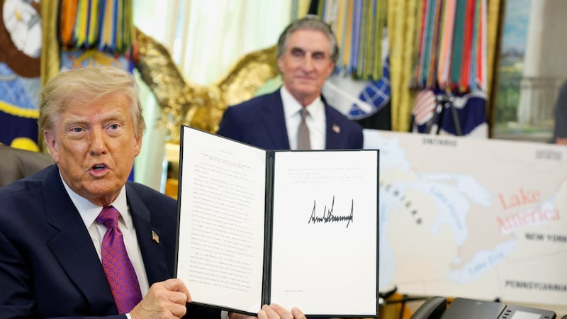 U.S. President Donald Trump holds up an executive order renaming Lake Ontario as Lake America after signing it at the Oval Office of the White House in Washington, D.C., U.S., August 27, 2026. REUTERS/Evan Vucci
