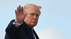 TOPSHOT - US President Donald Trump waves while boarding Air Force One at Palm Beach International Airport on November 30, 2025, on his way back to Washington, DC. President Trump and First Lady Melania Trump spent the Thanksgiving holiday at his Mar-a-Lago residence. (Photo by Jim WATSON / AFP via Getty Images)