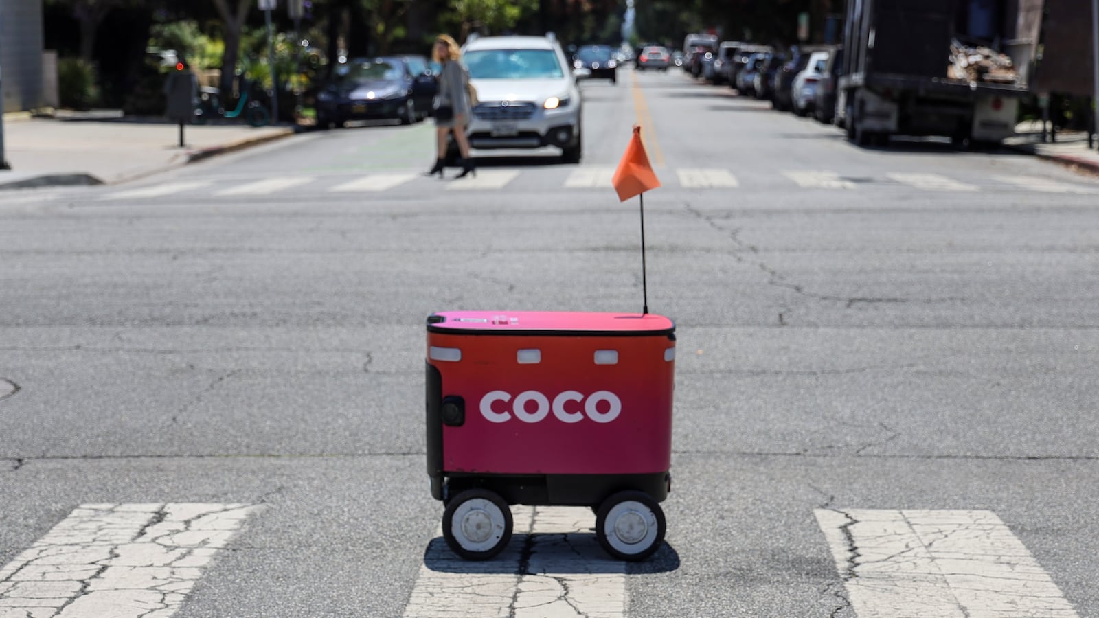 Santa Monica, CA, Wednesday, July 23, 2025 - A Coco food delivery robots crosses 11th St. as it travels along Montana Ave. from Kreation Kafe. (Robert Gauthier/Los Angeles Times via Getty Images)