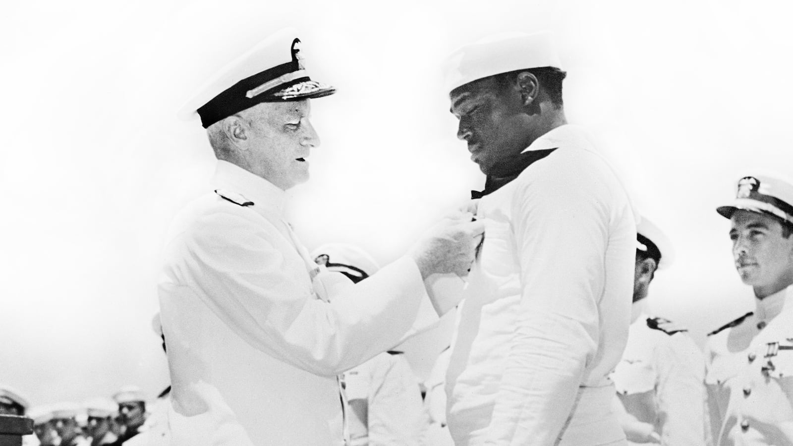 Admiral Chester W. Nimitz pinning Navy Cross on Doris "Dorie" Miller at ceremony aboard the USS Enterprise, Pearl Harbor, Hawaii, U.S. Office of War Information, May 27, 1942.