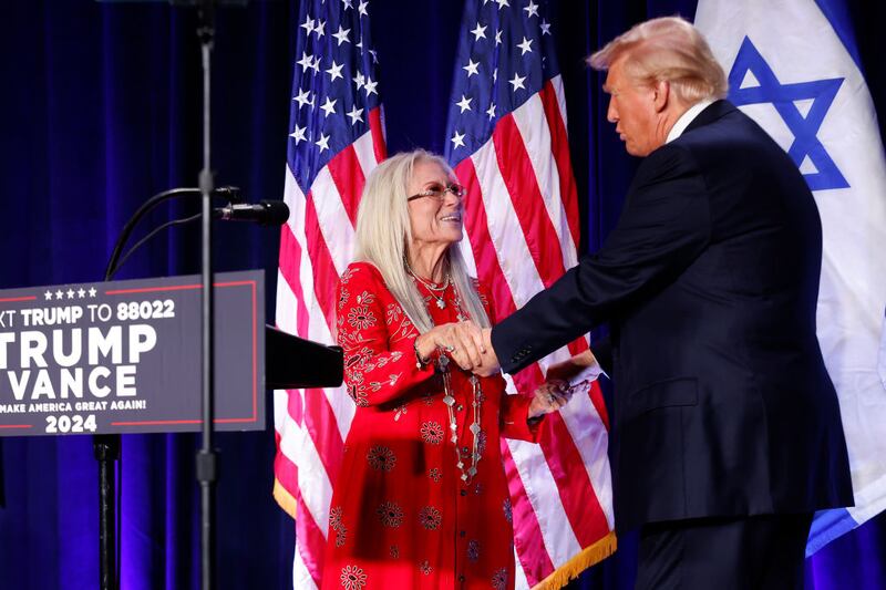Miriam Adelson, widow of billionaire casino magnate Sheldon Adelson, welcomes Republican presidential nominee, former U.S. President Donald Trump to the stage to speak before prominent Jewish donors at an event titled  "Fighting Anti-Semitism in America" at the Hyatt Regency Capitol Hill on September 19, 2024 in Washington, DC.