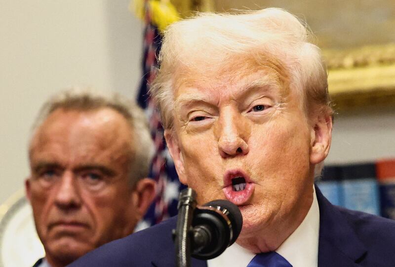 U.S. President Donald Trump, in front of U.S. Secretary of Health and Human Services Robert F. Kennedy Jr., delivers remarks at the White House, in Washington, D.C., U.S., September 22, 2025. REUTERS/Kevin Lamarque