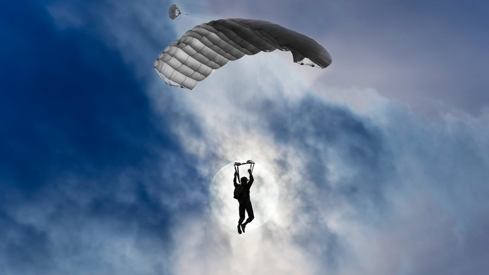 Skydiver and full moon with clouds.