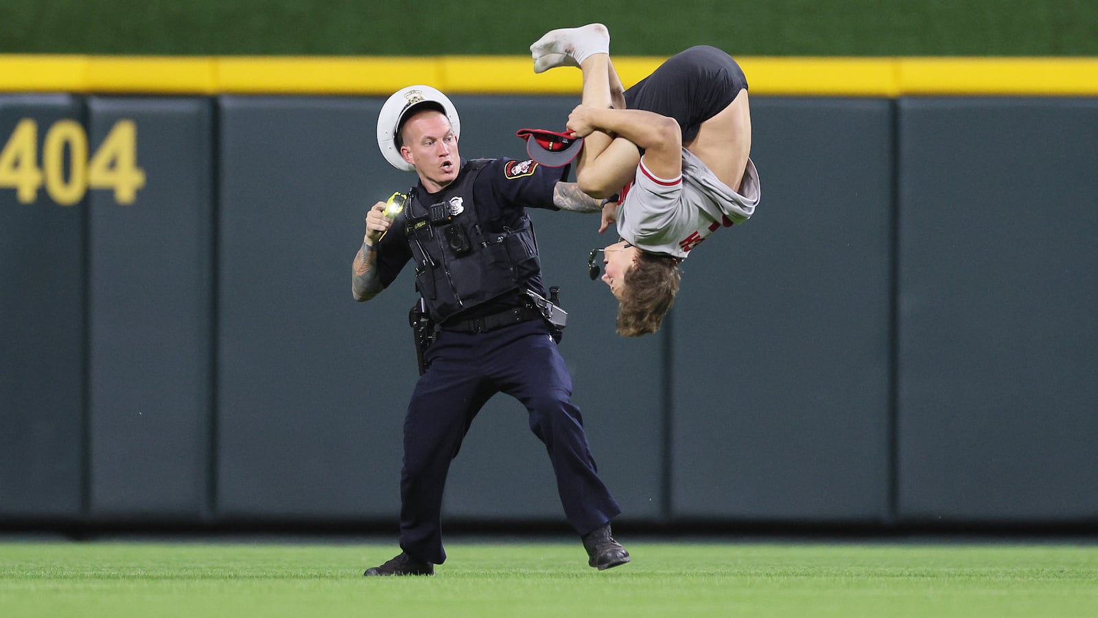 William Hendon does a backflip while a police officer attempts to tase him.