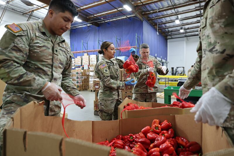 Members of the California National Guard pack produce for distribution amid the suspension of SNAP benefits during the federal government shutdown at a food bank in Los Angeles on October 30, 2025.