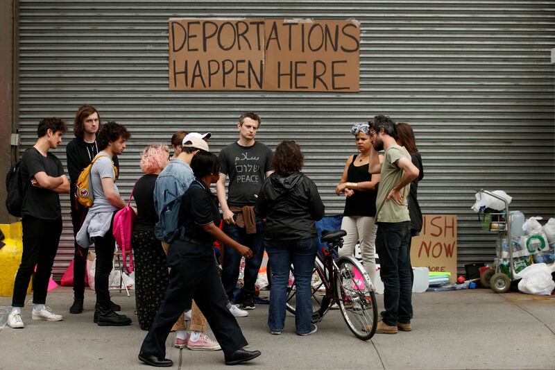 Demonstrators gather outside a building