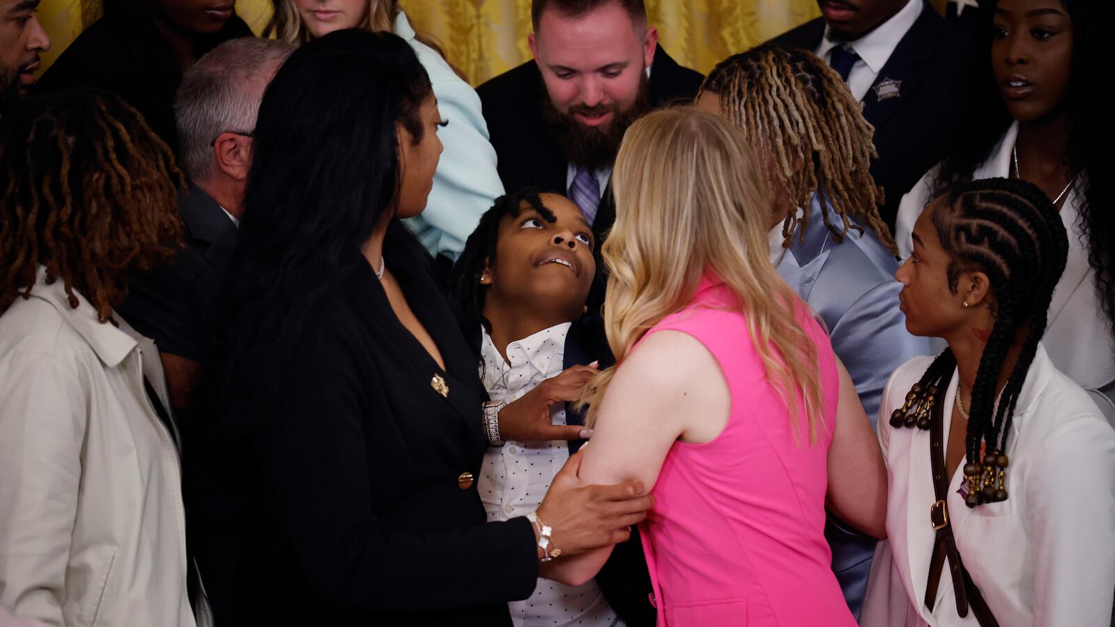 Louisiana State University team member Sa'Myah Smith (C) is supported by her teammates while collapsing during a celebration of the team's NCAA Division I women's basketball national championship in the East Room of the White House.