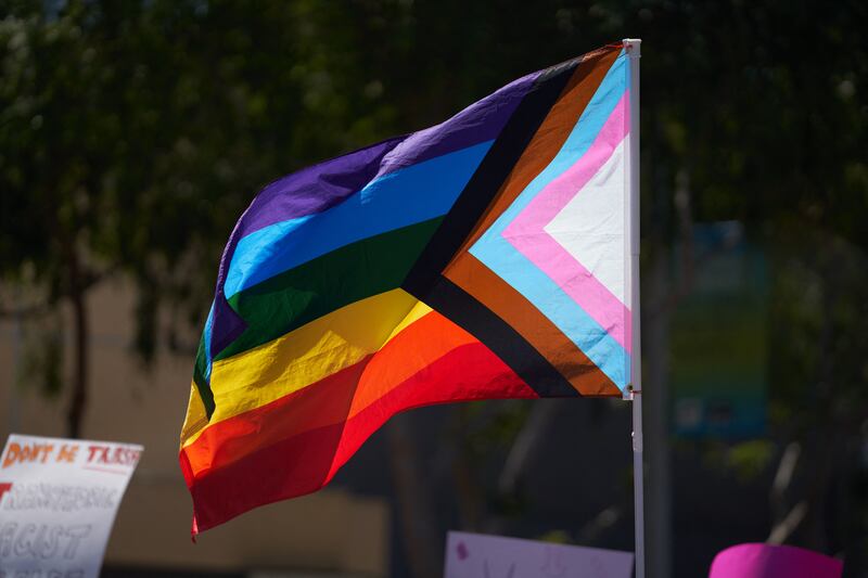 A Progress Pride Flag is held above the crowd of LGBTQ+ activists during the Los Angeles LGBT Center's "Drag March LA: The March on Santa Monica Boulevard", in West Hollywood, California, on Easter Sunday April 9, 2023. The march comes in response to more than 400 pieces of legislation targeting the LGBTQ+ community that government officials across the United States have proposed or passed in 2023. (Photo by ALLISON DINNER / AFP) (Photo by ALLISON DINNER/AFP via Getty Images)