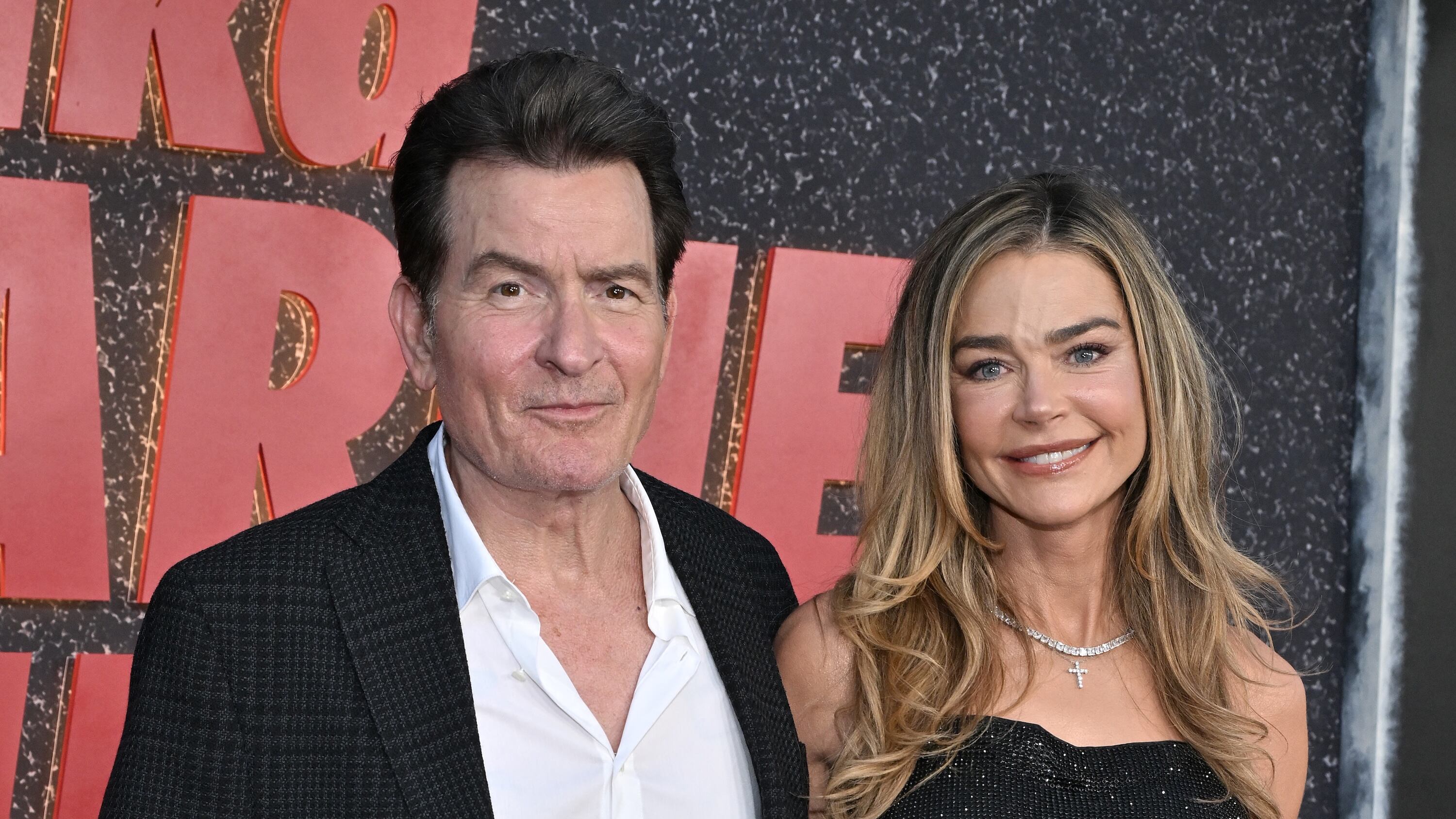 US actor Charlie Sheen and US actress Denise Richards attend the Los Angeles premiere of Netflix's "aka Charlie Sheen" at the Tudum theatre in Hollywood, California, on September 4, 2025. (Photo by LISA O'CONNOR / AFP)