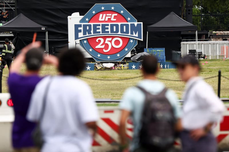 People look at a sign of the UFC Freedom 250 fight card, near the White House in Washington, D.C., U.S., June 9, 2026. REUTERS/Kevin Lamarque