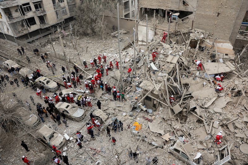 Emergency personnel work at the site of a strike on a residential building, amid the U.S.-Israeli conflict with Iran, in Tehran, Iran, March 16, 2026.