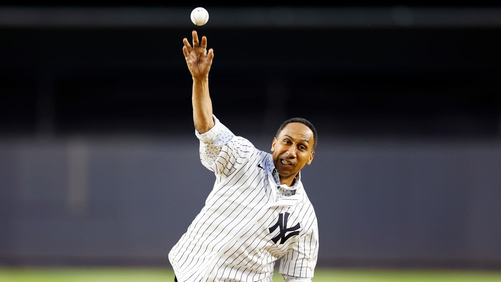American TV personality Stephen A. Smith throws a ceremonial first pitch before the first inning of the game
