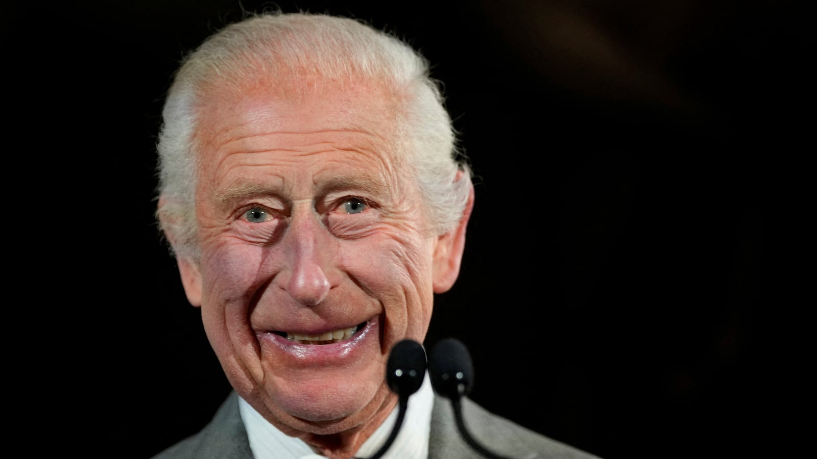 King Charles III smiles.
