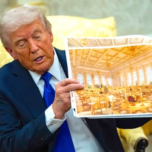 President Donald Trump speaks holding a photos of the new ballroom in the Oval Office of the White House in Washington, D.C. on October 22, 2025.