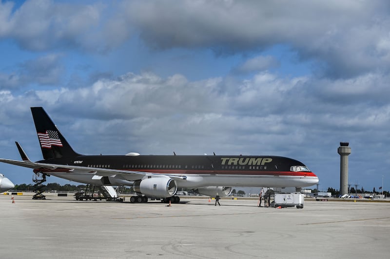 Ground staff work on a private plane of former US President Donald Trump at Palm Beach International Airport in Palm Beach, Florida, on March 22, 2023. - A grand jury was set to reconvene in New York on Wednesday as it weighs whether to charge ex-president Donald Trump over hush money paid to a porn star. (Photo by CHANDAN KHANNA / AFP) (Photo by CHANDAN KHANNA/AFP via Getty Images)